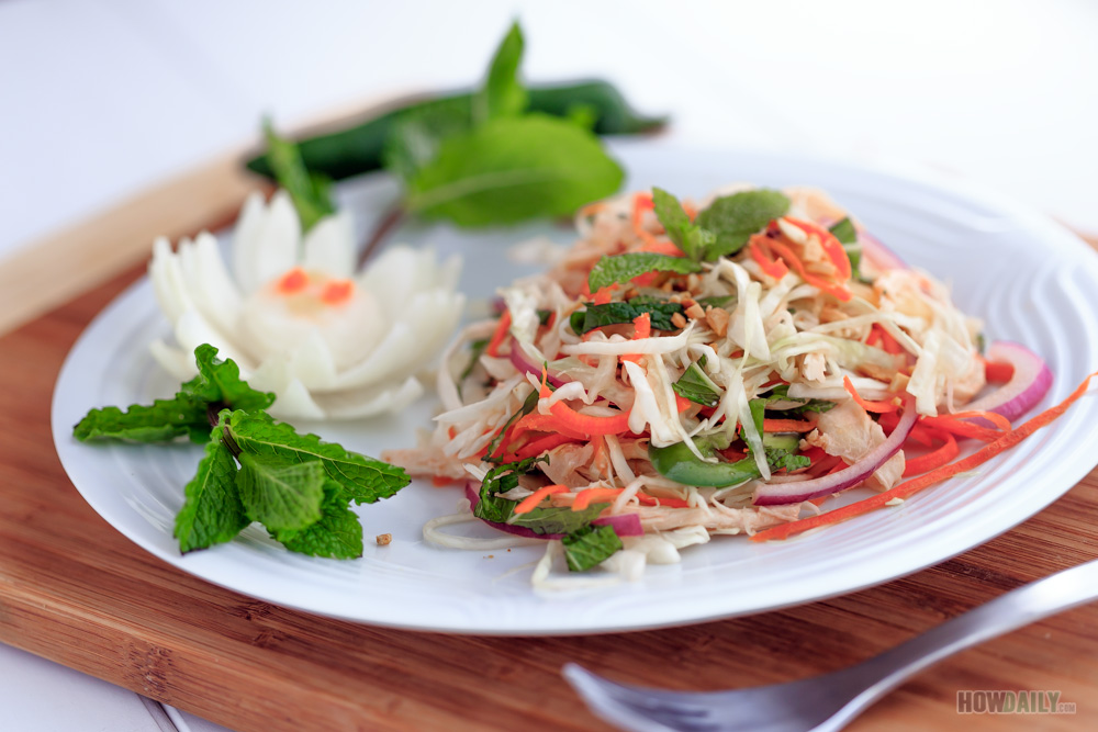 Shred cabbage and onion in Vietnamese chicken salad