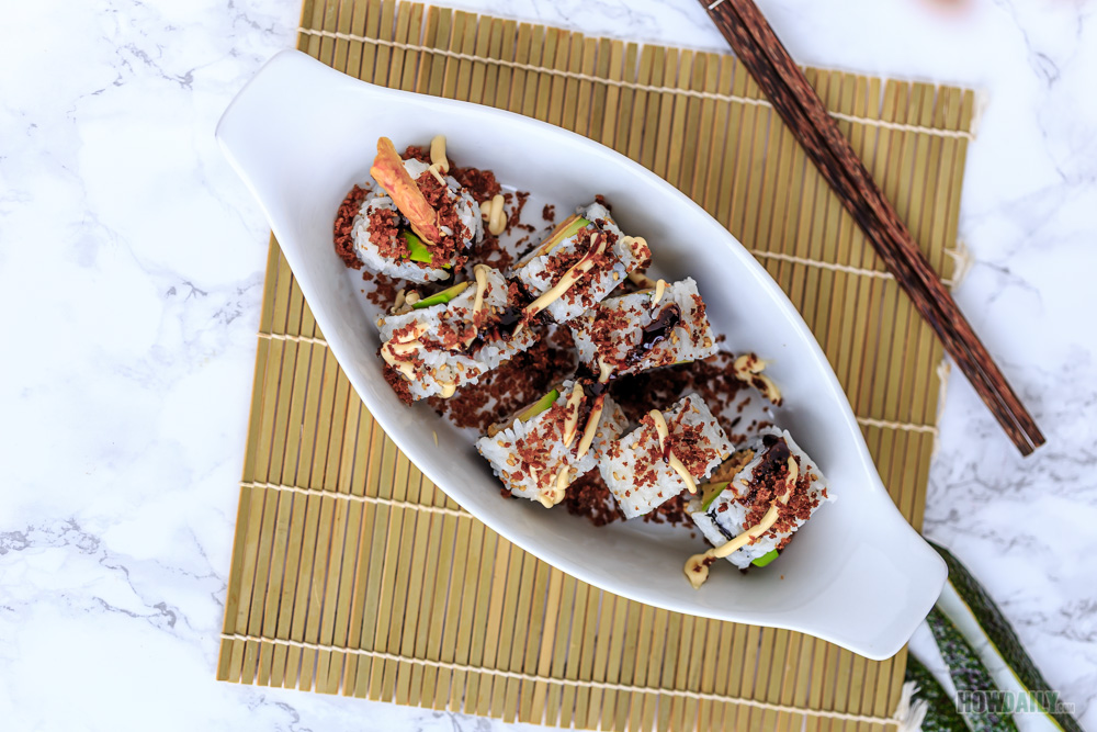 Top kewpie mayo and unagi sauce on shrimp tempura rolls